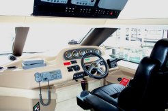 The captains chair in the pilot house, with the autopilot (joystick on the seat) and bow thruster visible on the dash. Lots of stuff for navigation.